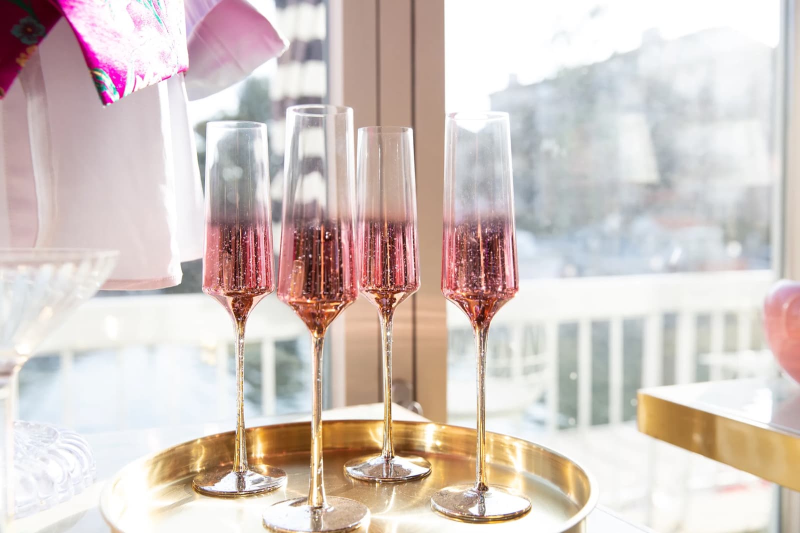 Four rosé flutes catching the waterfront light