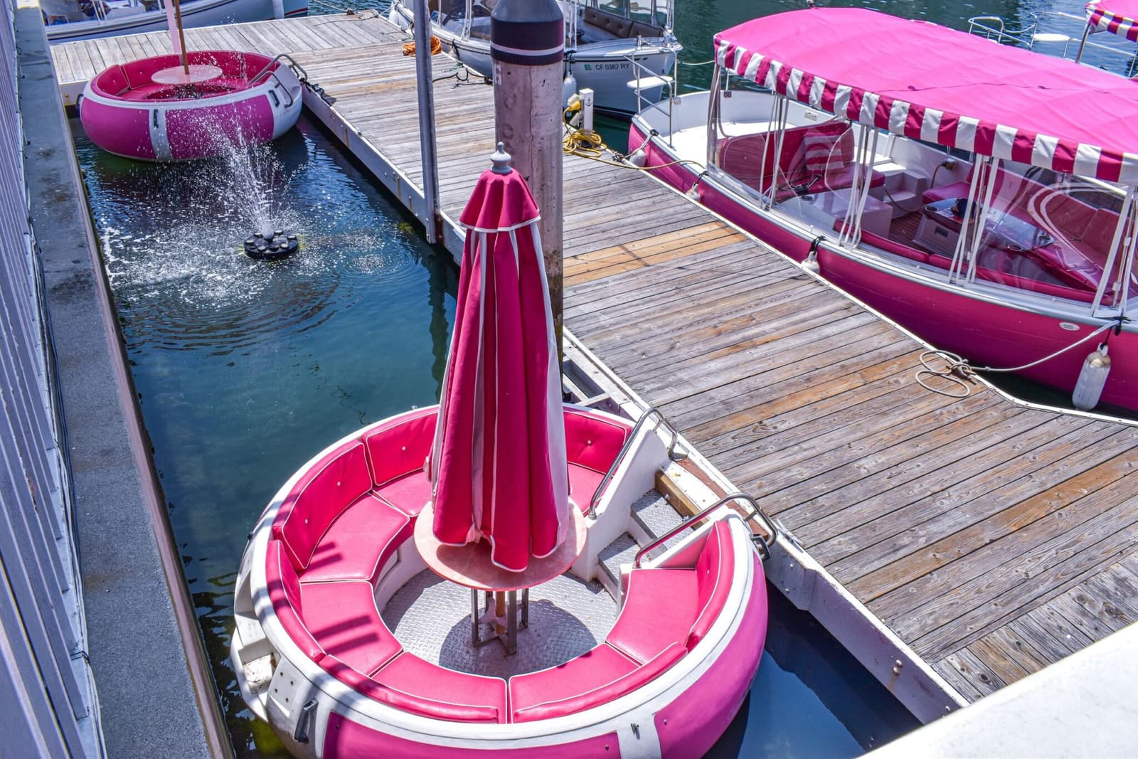 Pink Duffy boats and round floating seats at the Nigel's dock