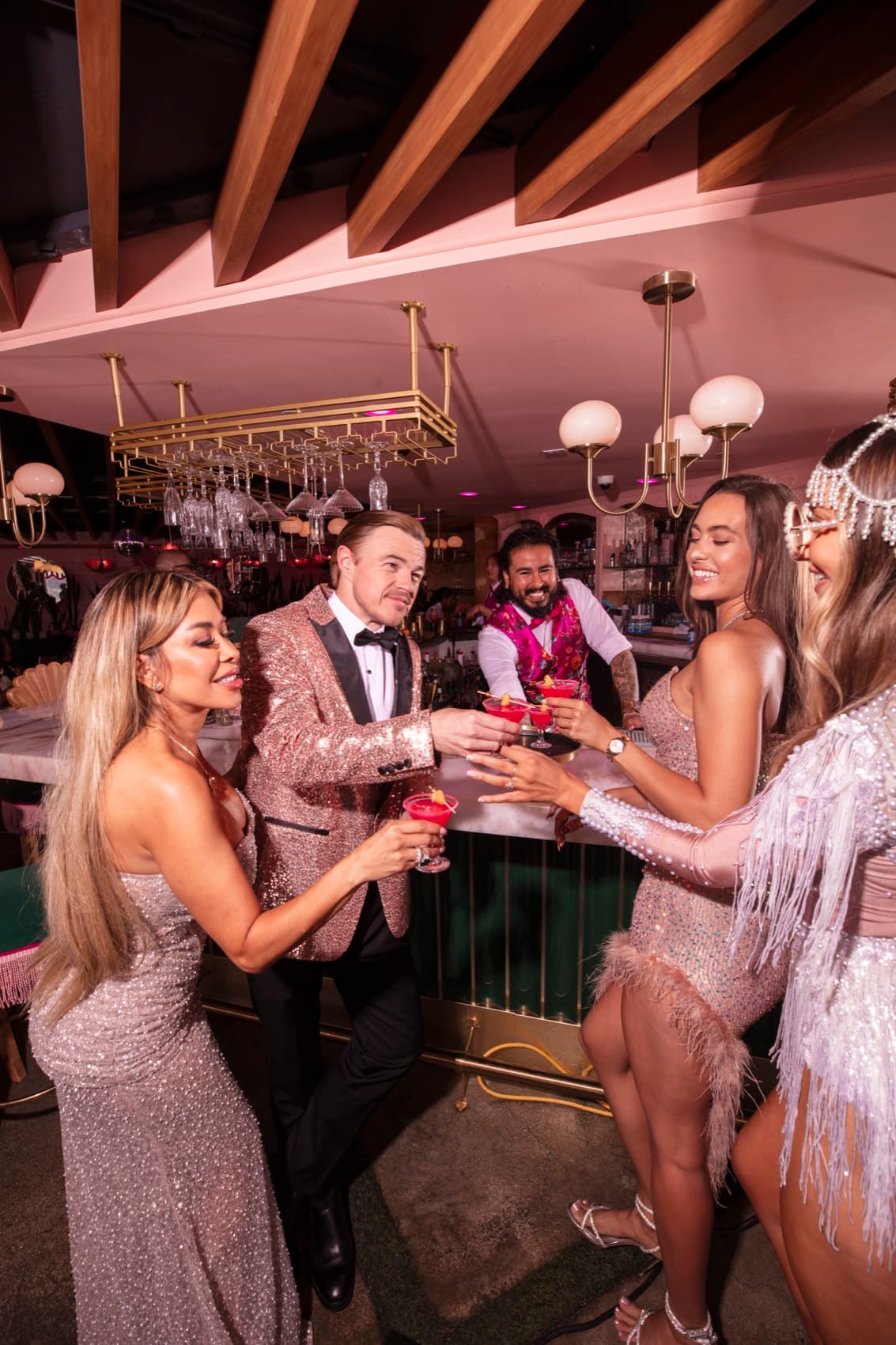 The whole crew toasting with the bartender