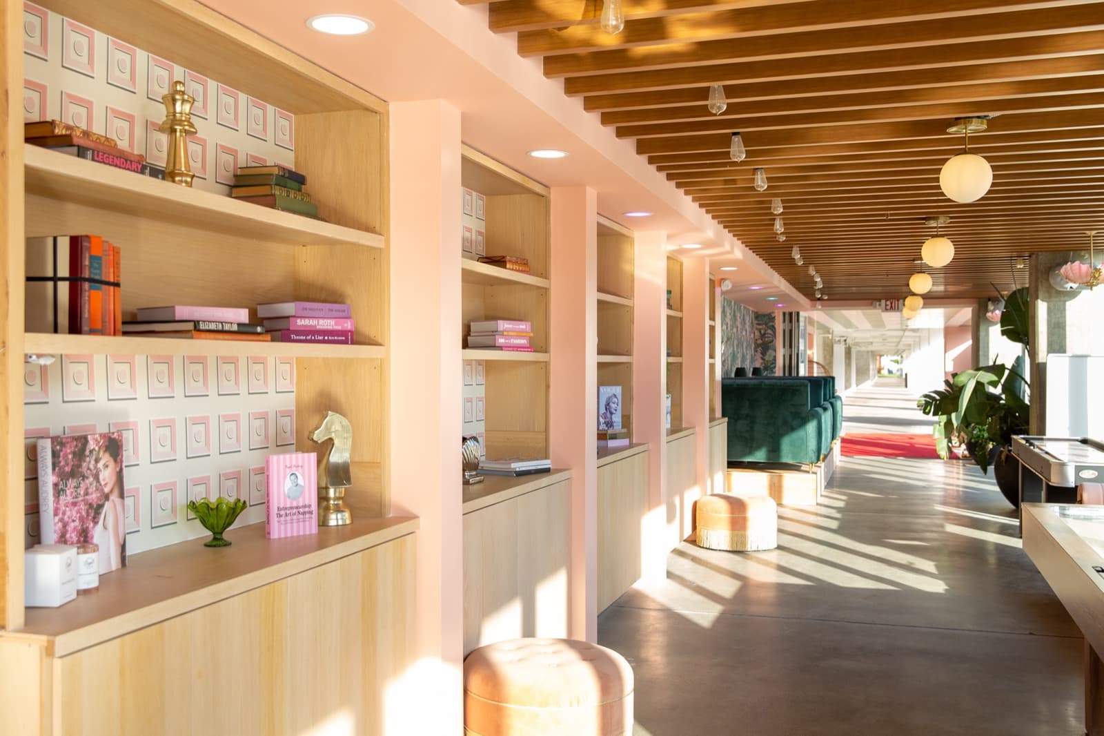 Curated shelves of fashion books in golden light