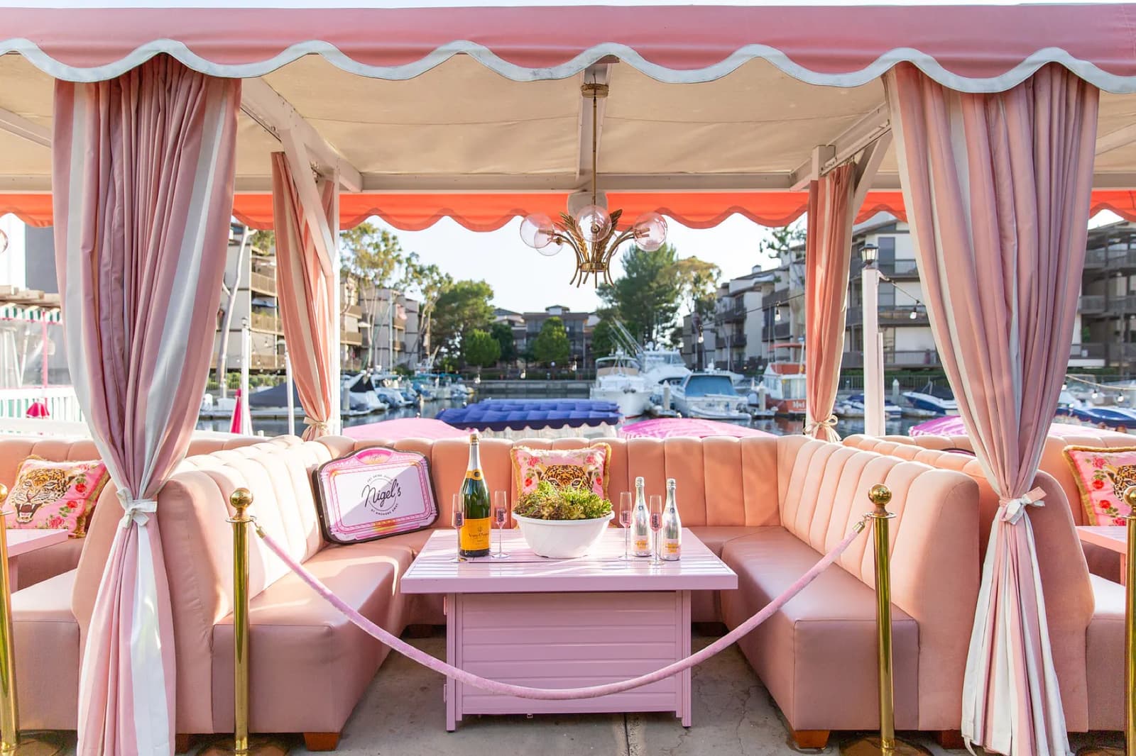 Pink cabana seating and Veuve aboard the Duffy