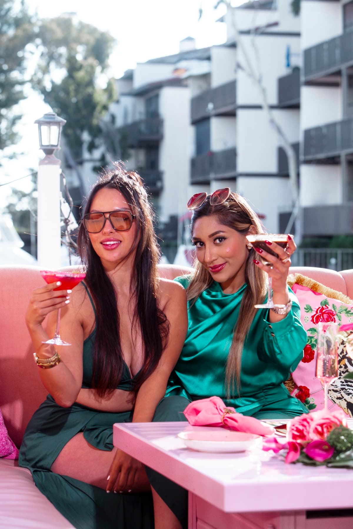 Guests raising cocktails on a pink Duffy boat at the Nigel's dock